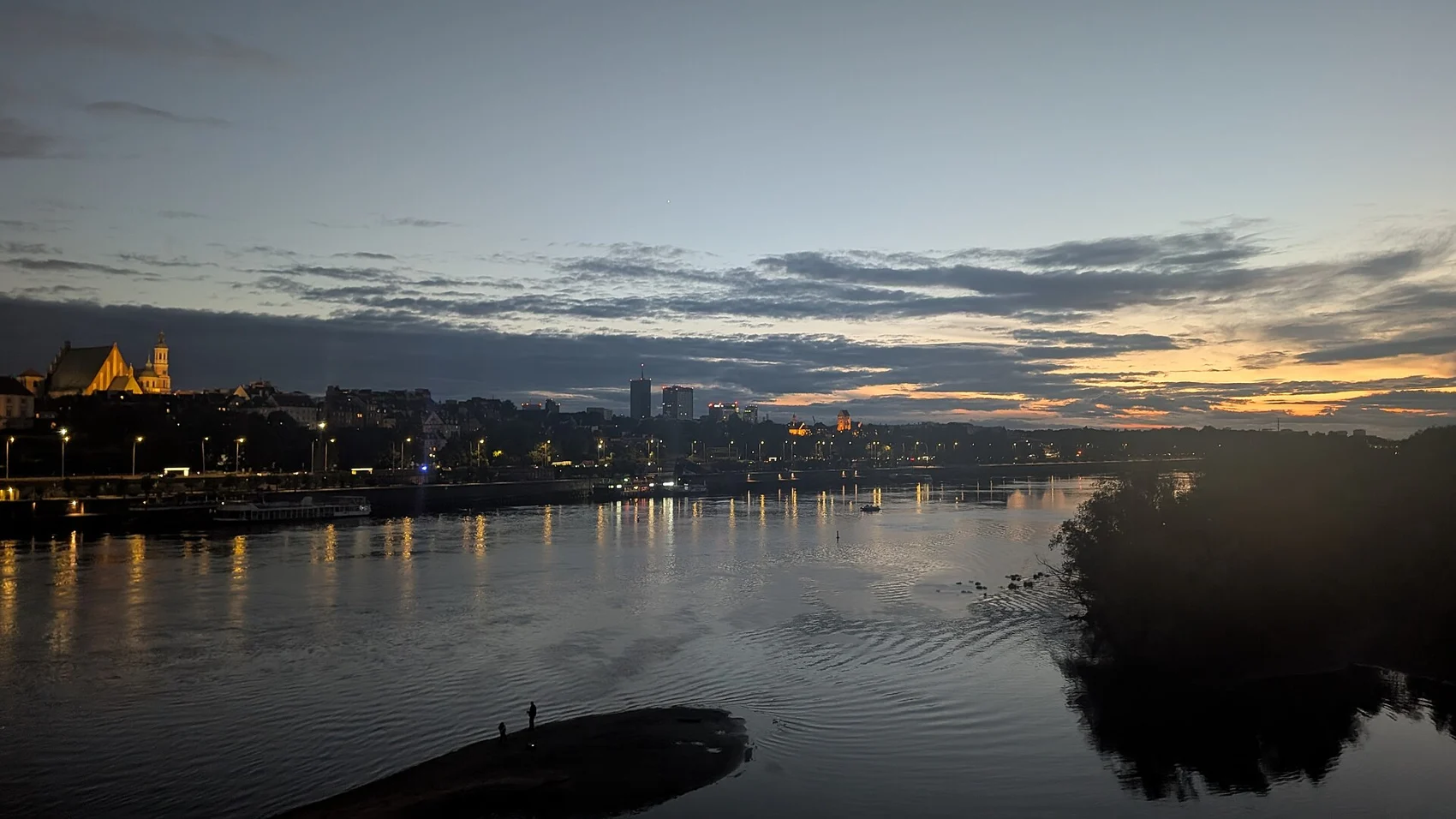 Warsaw skyline and river at dusk; city context photograph